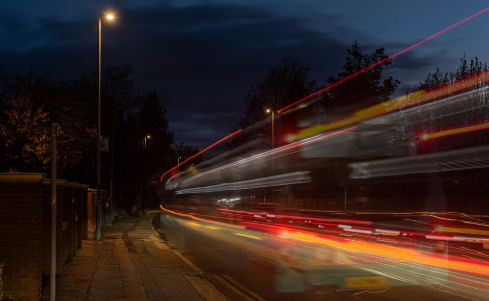 LED street lighting on a residential street with traffic blur