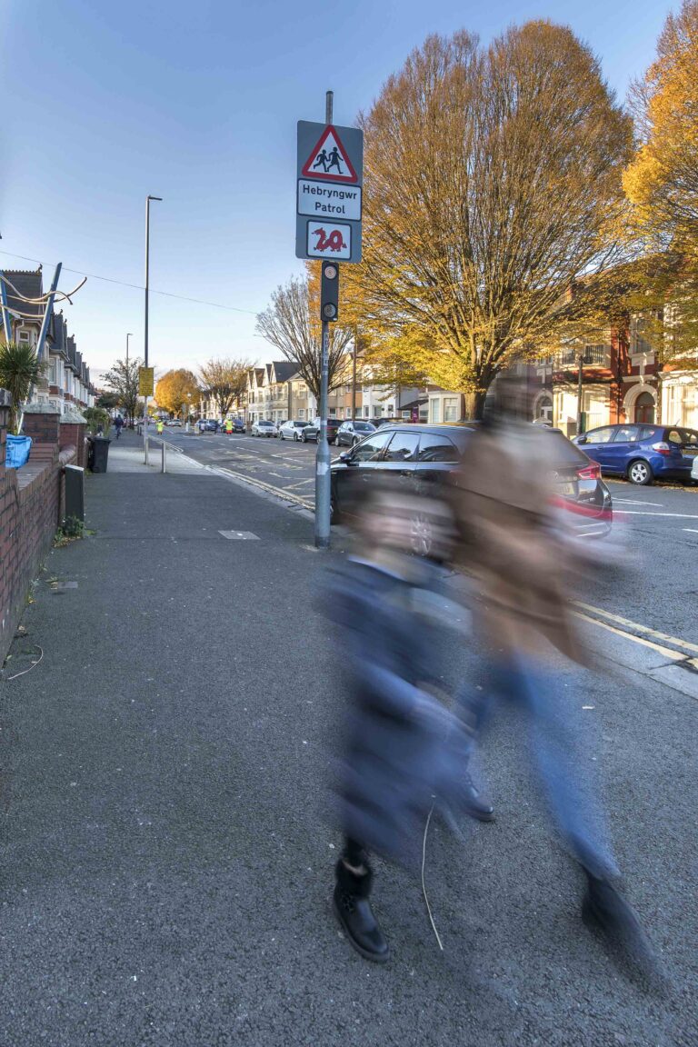 twin amber road safety light with parent and child walking past